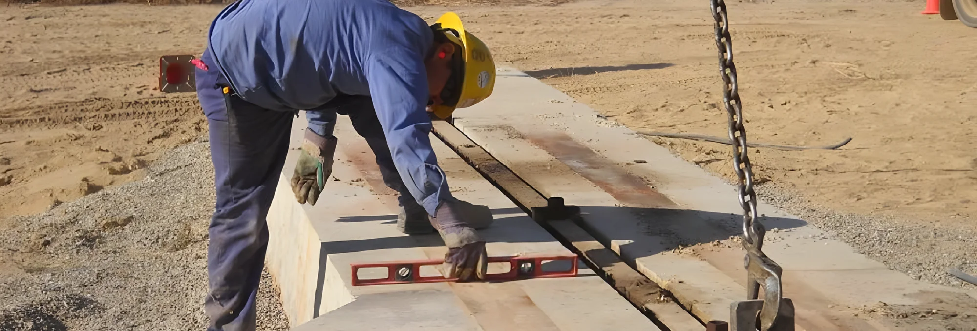 ULT field technician levelling a pumping unit foundation